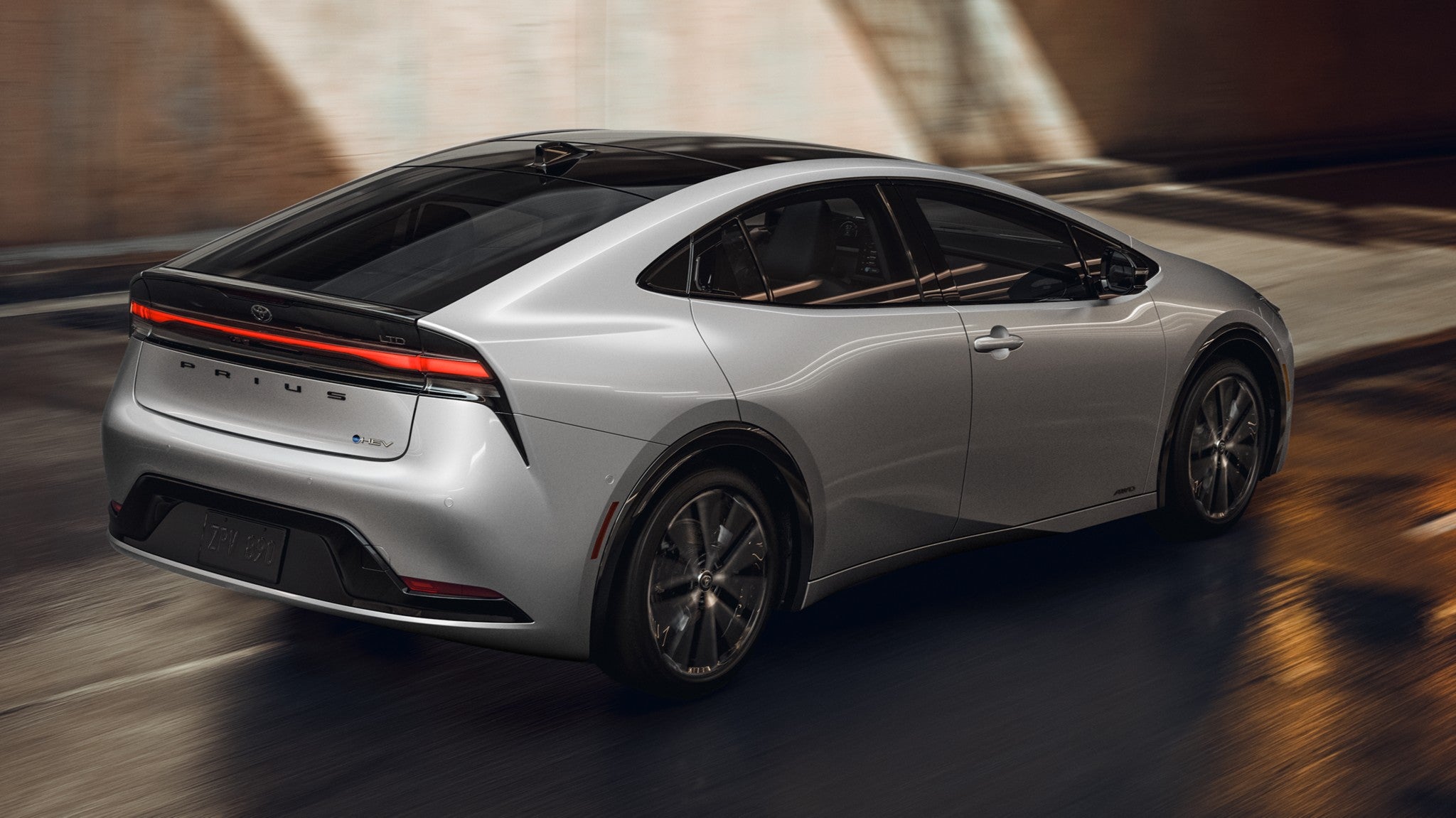 A silver Toyota Prius driving through a tunnel