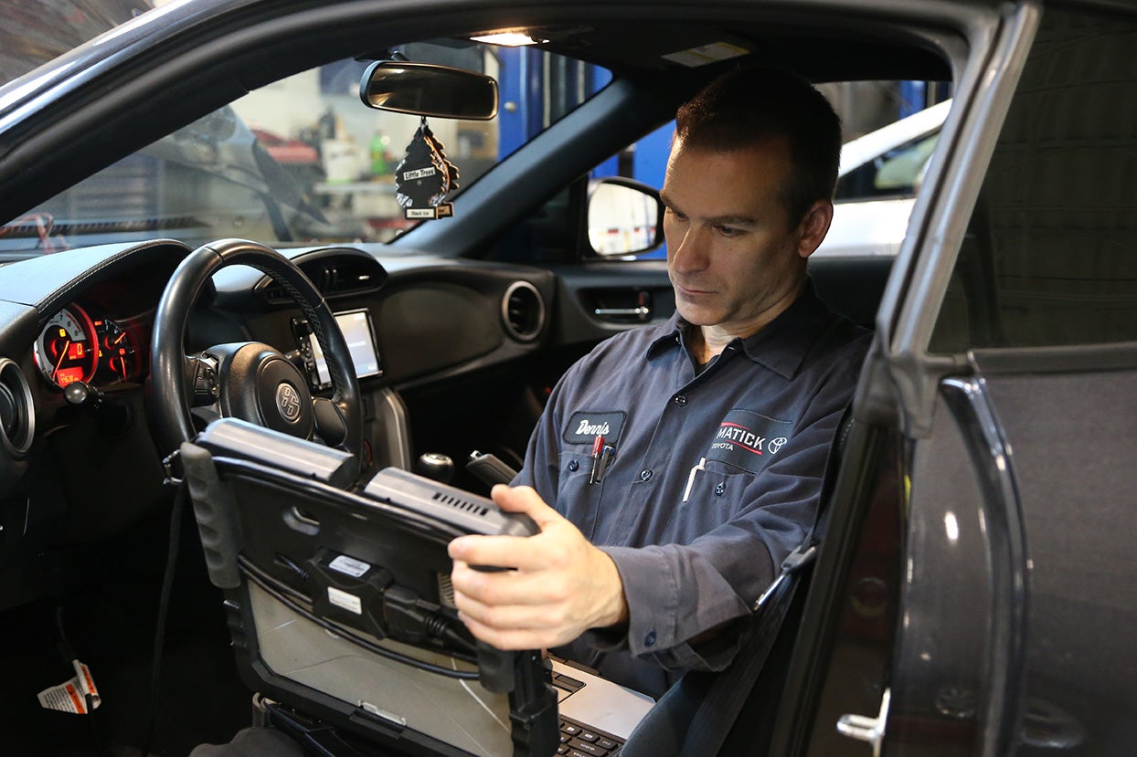 A Matick Toyota technician working on a vehicle